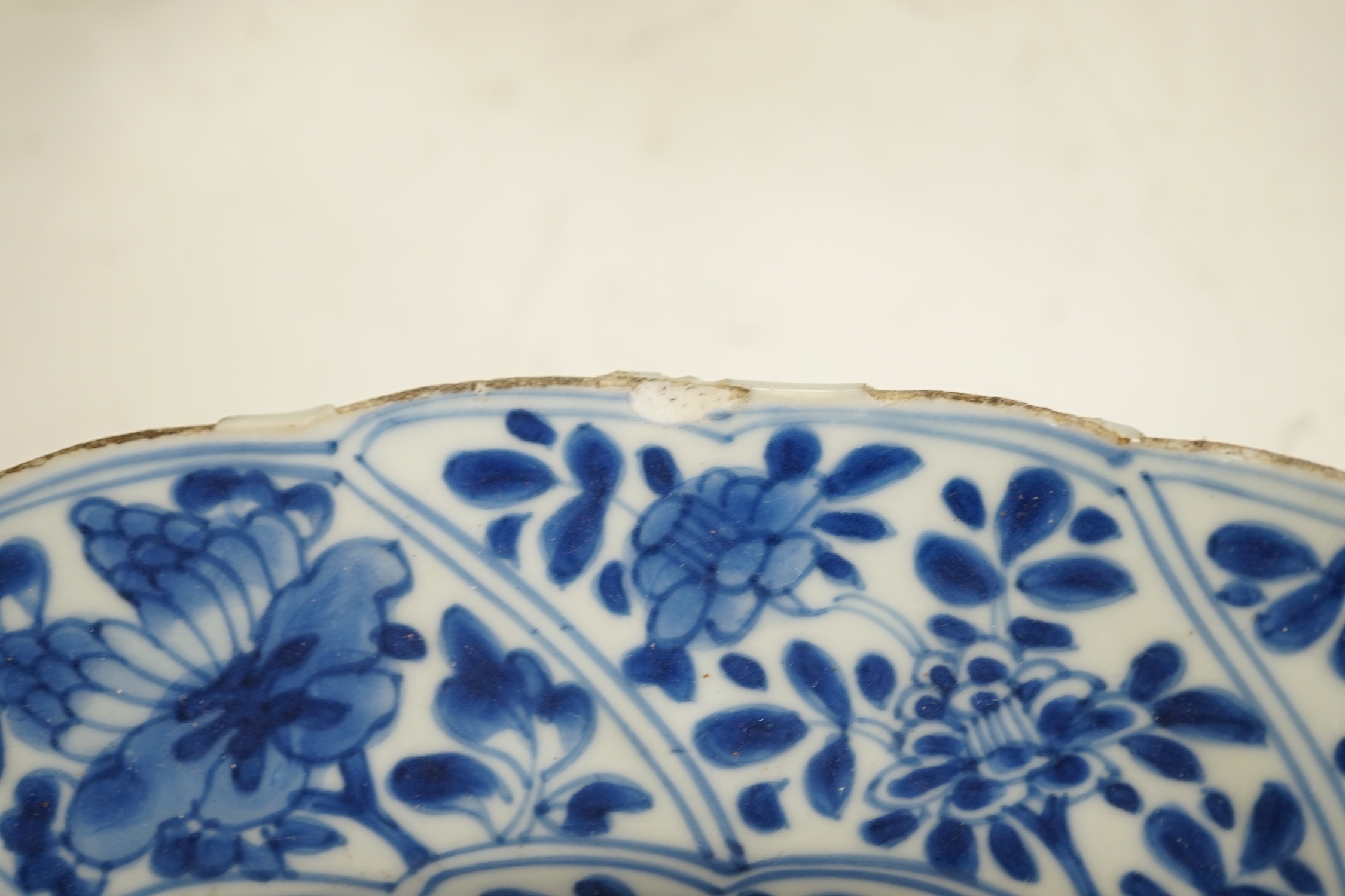 A pair of Chinese Kangxi blue and white dishes, painted with rock work and flowers, artemisia leaf marks, 37cm diameter